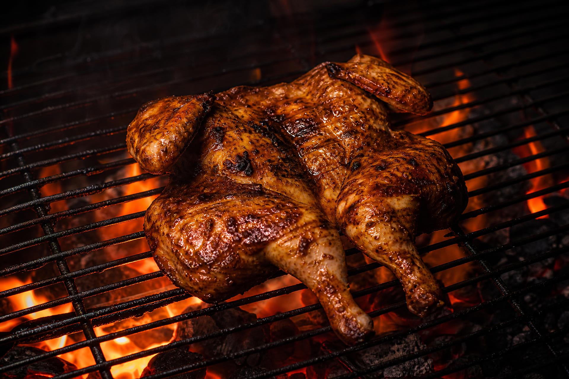 Portuguese piri-piri chicken flame-grilled over glowing charcoal